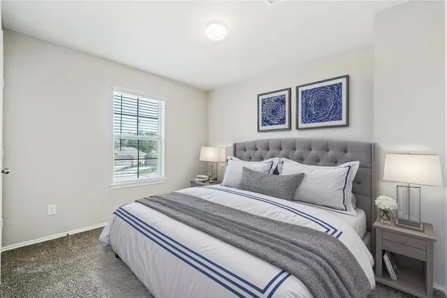 a bedroom with bed and a window