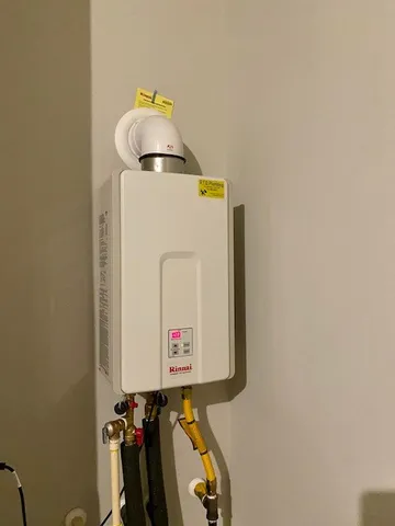 a sign of golf club on a wall under a tree