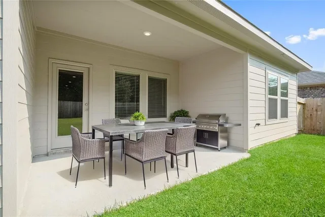 a view of a house with a backyard and a patio