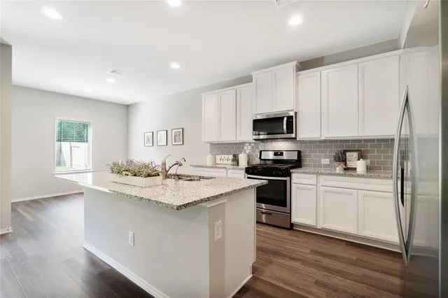a kitchen with a sink stove and microwave