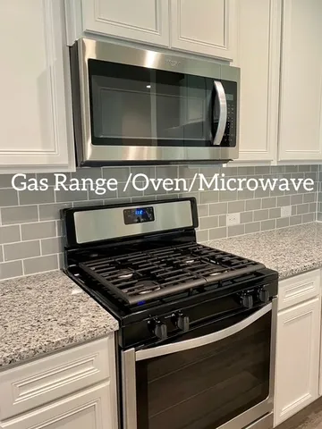 a stove top oven sitting inside of a kitchen