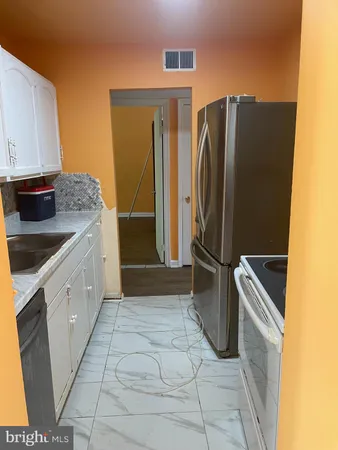 a close view of a sink and dishwasher with kitchen island