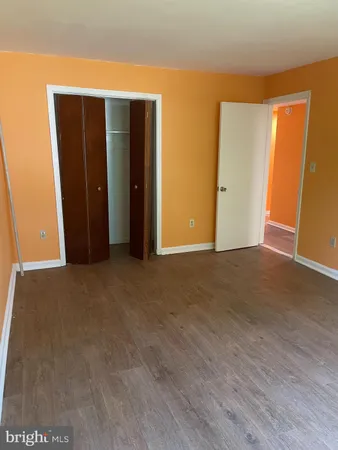 an empty room with wooden floor