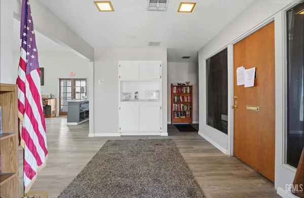 a living room with furniture and kitchen view