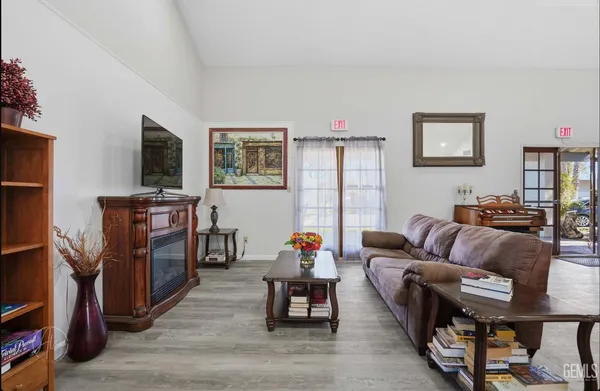 a living room with furniture a dining table and a flat screen tv