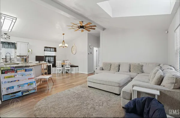 a living room with furniture and a dining table