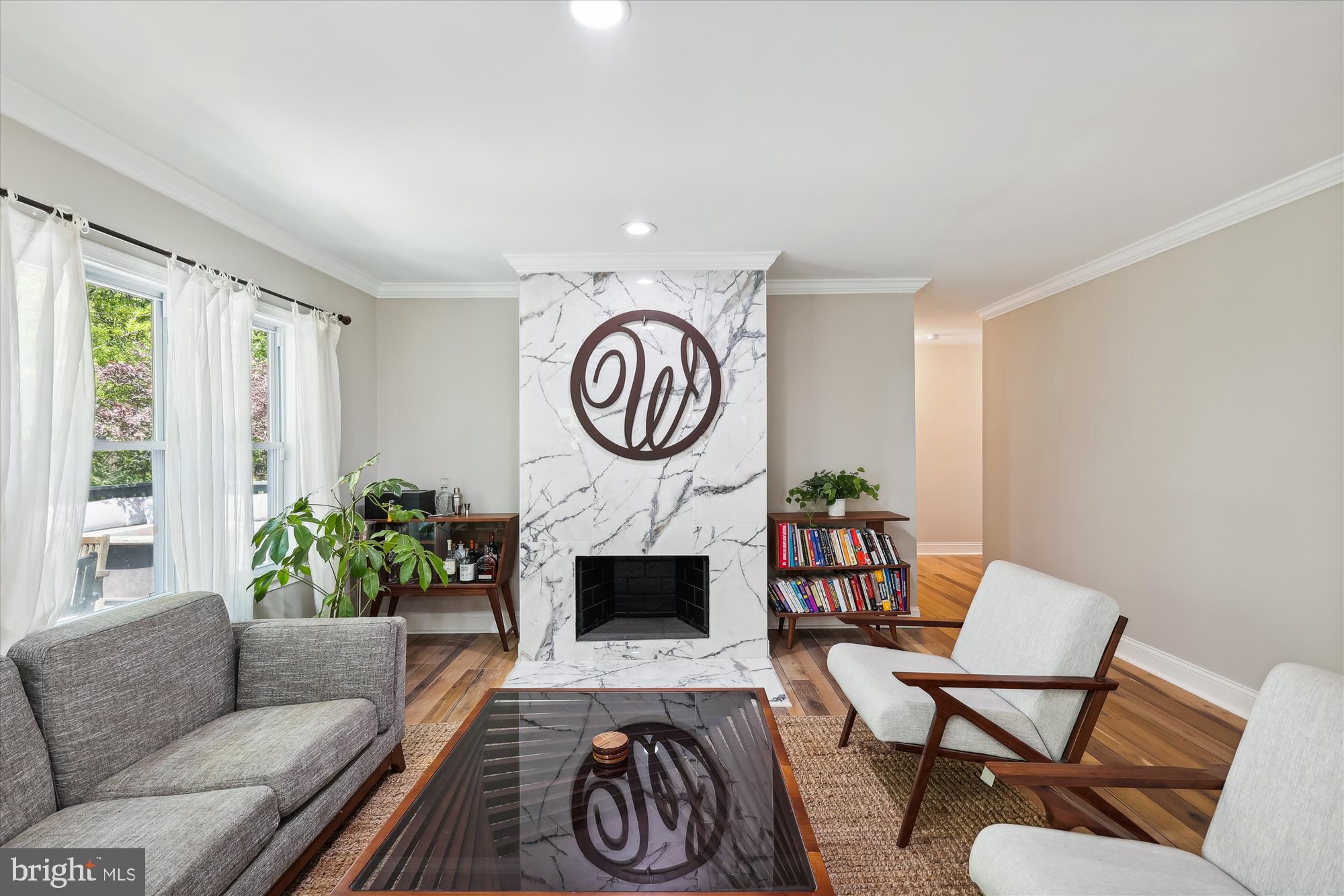 a living room with furniture a rug and a window