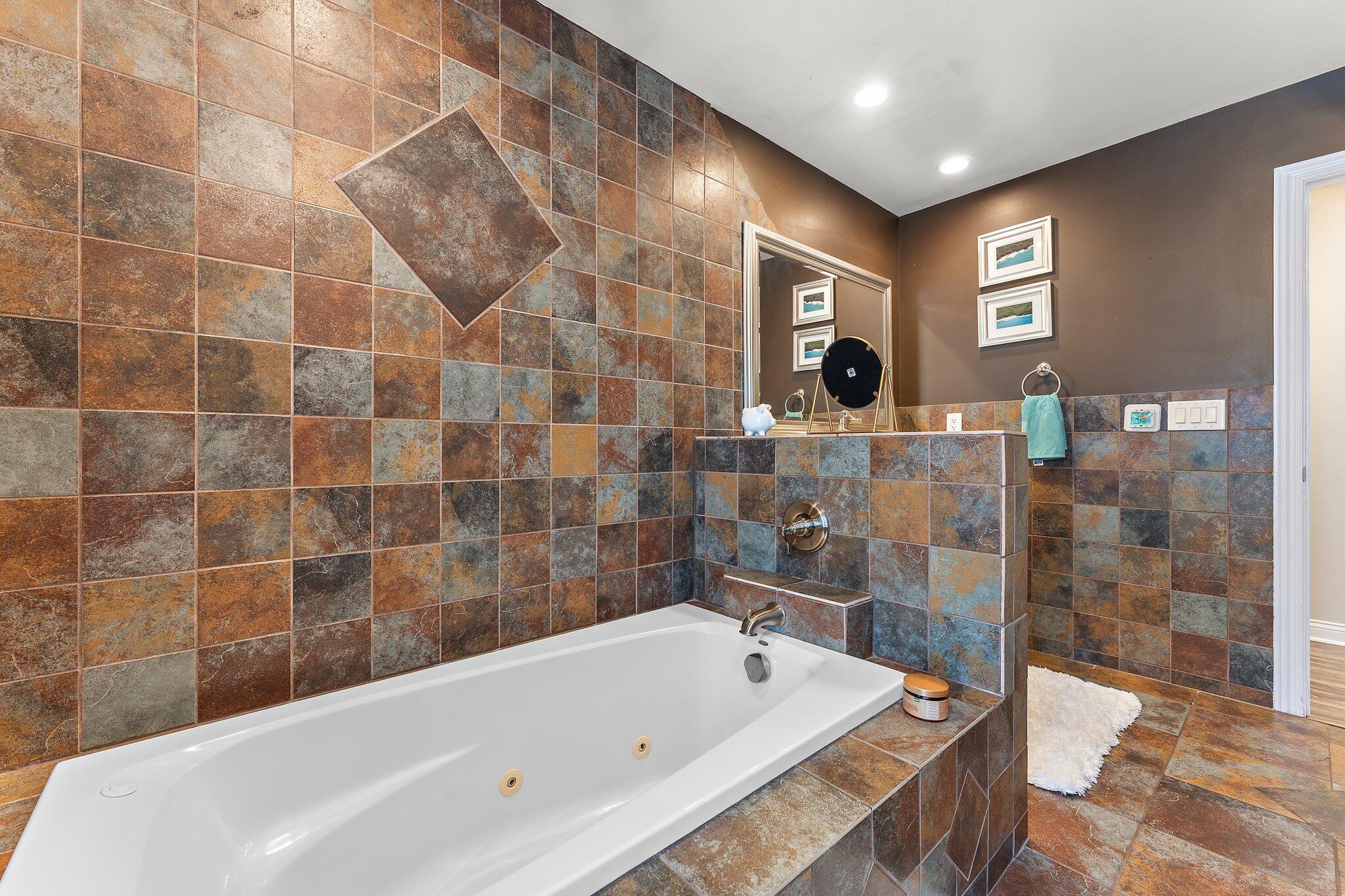 11728 Monroe Place Crown Point, IN 46307 - Photo 20 of 44 a bathroom with a bathtub and a shower