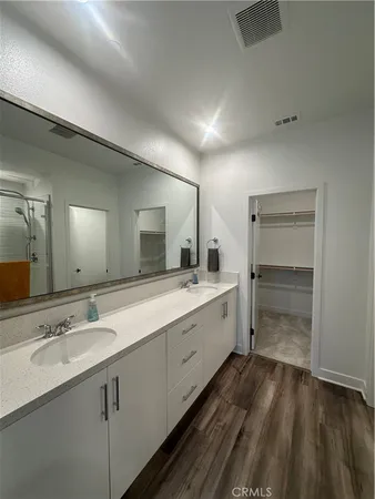 a bathroom with a double vanity sink and mirror