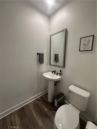 a bathroom with a toilet a sink and mirror