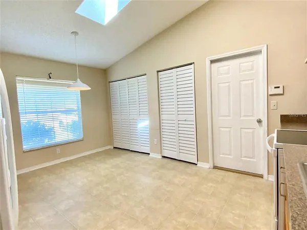 an empty room with windows and closet