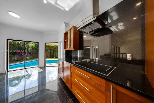 a kitchen with counter top space and living room