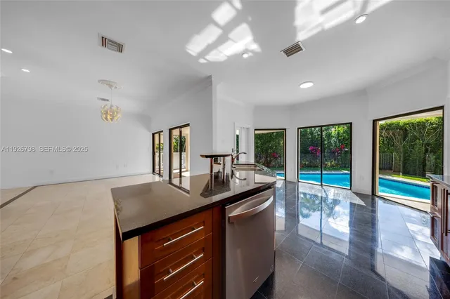 a view of a kitchen with a refrigerator and a chandelier
