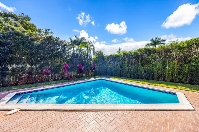 a view of swimming pool with chairs in patio