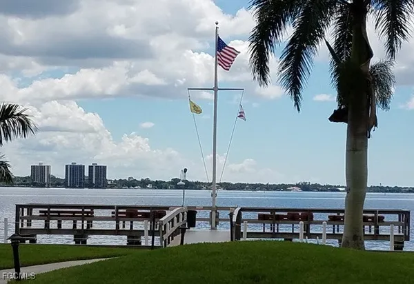 a view of swimming pool with outdoor seating and trees