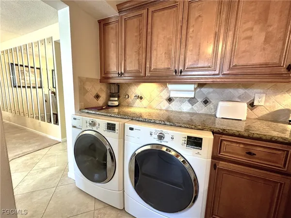 a utility room with sink dryer and washer