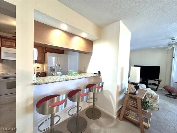 a room with a couch and a view of living room