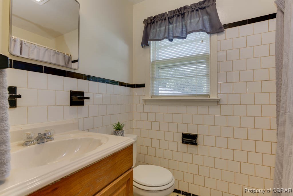 3204 West Weaver Road Hampton, VA 23666 - Photo 17 of 27 Bathroom with curtained shower, vanity, tile walls, and toilet