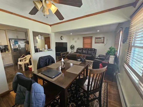 a view of a dining room with furniture window and wooden floor