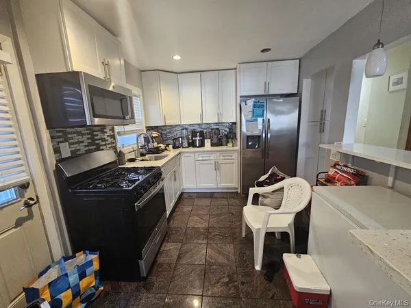 a kitchen with a stove a refrigerator and a sink