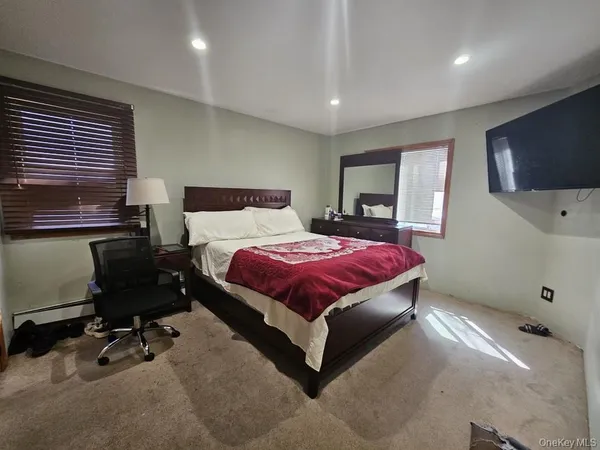 a bedroom with a bed a desk and chair