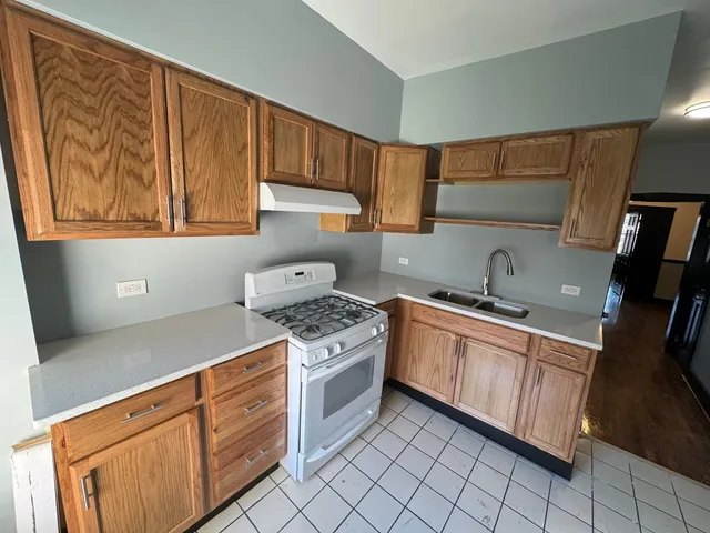 a kitchen with a sink stove and cabinets