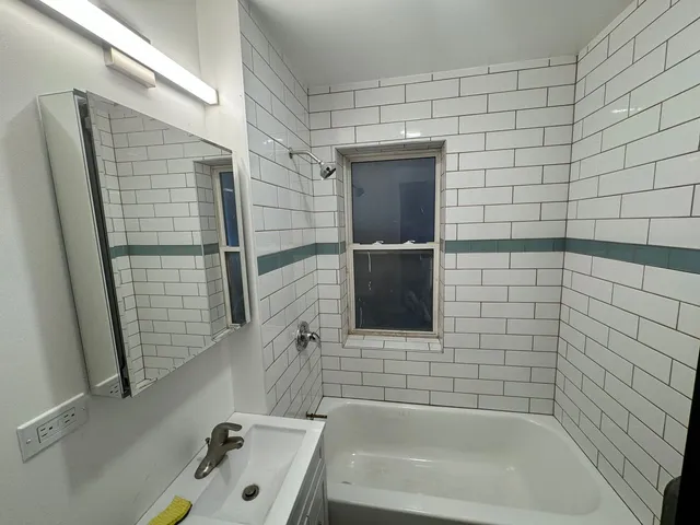 a bathroom with a bathtub and shower