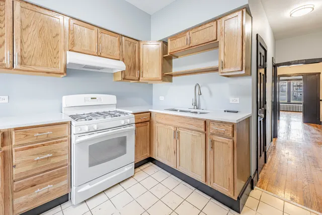 a kitchen with cabinets appliances and a window