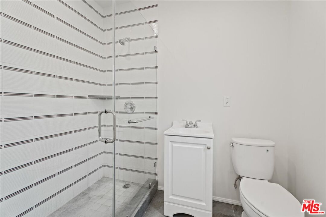 207 South Reeves Drive Beverly Hills, CA 90212 - Photo 7 of 13 a bathroom with a toilet and a shower