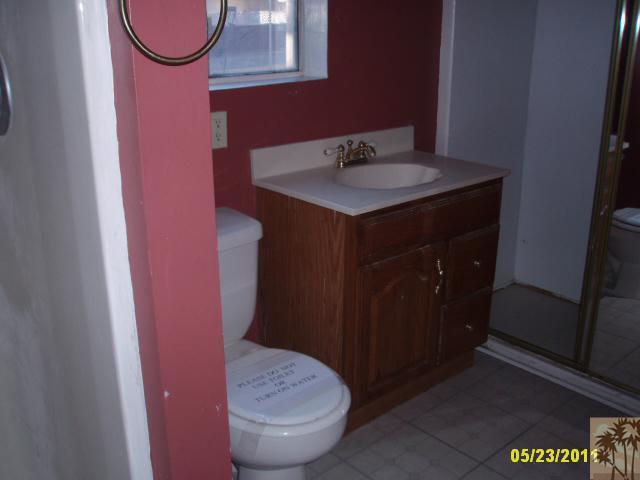 3595 Verde Street Riverside, CA 92504 - Photo 8 of 9 a bathroom with a sink a toilet and a mirror