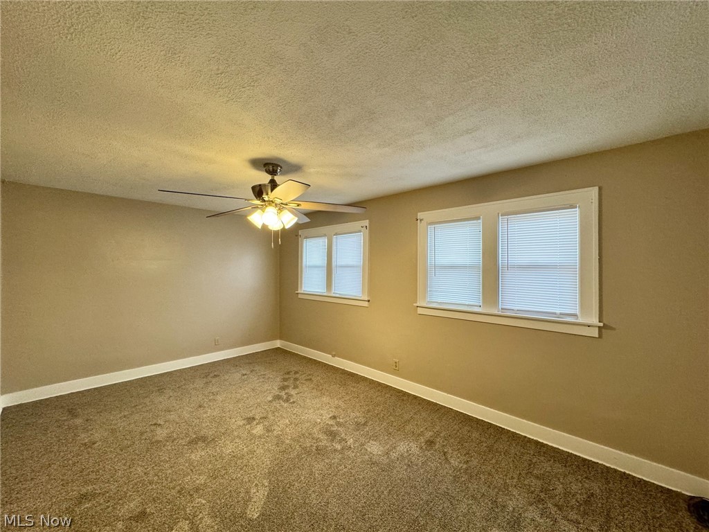 507 Canton Road Wintersville, OH 43953 - Photo 24 of 45 Carpeted empty room featuring a textured ceiling and ceiling fan