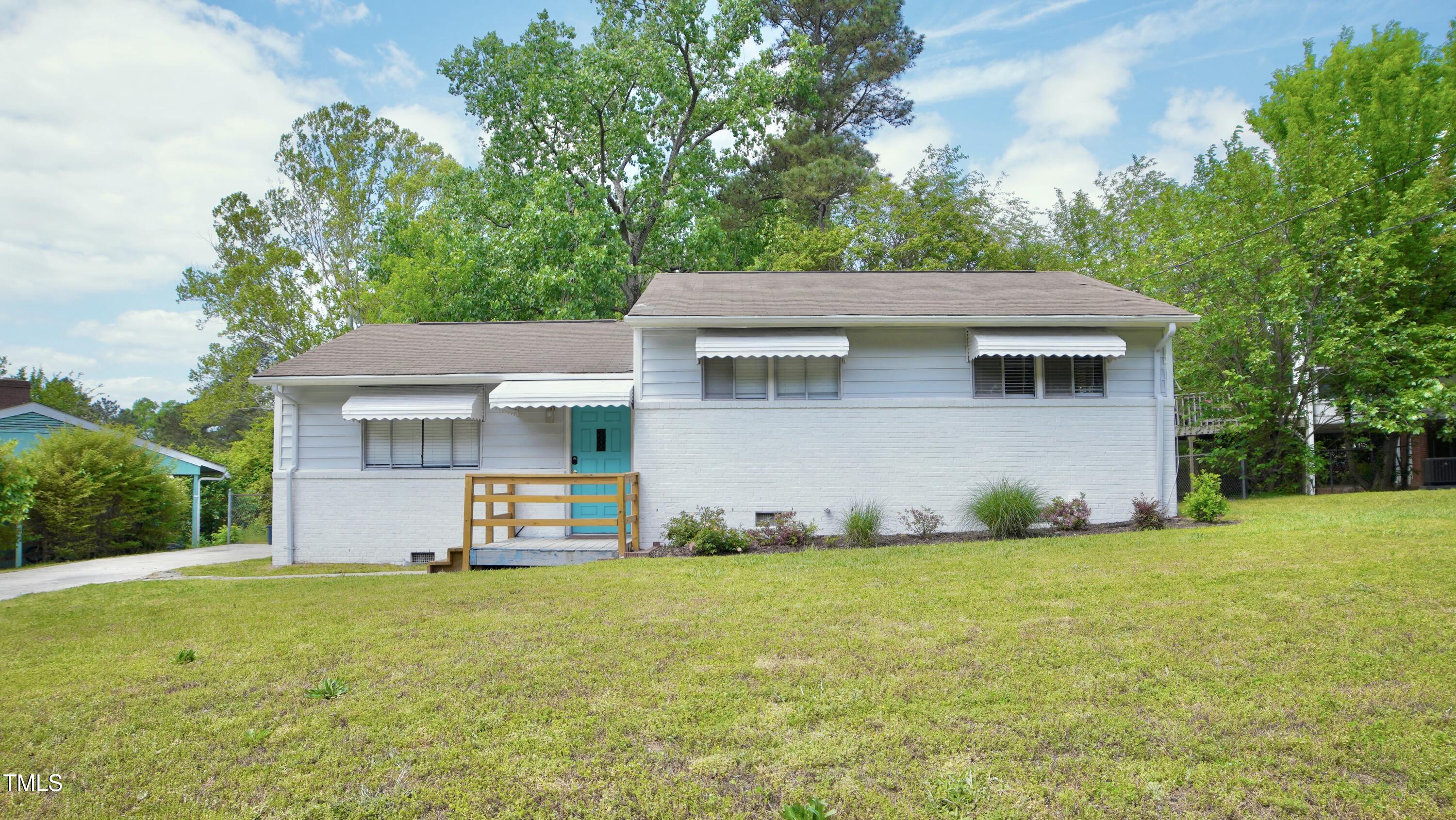 2006 Waters Drive Raleigh, NC 27610 - Photo 1 of 16 a front view of house with yard and trees in the background