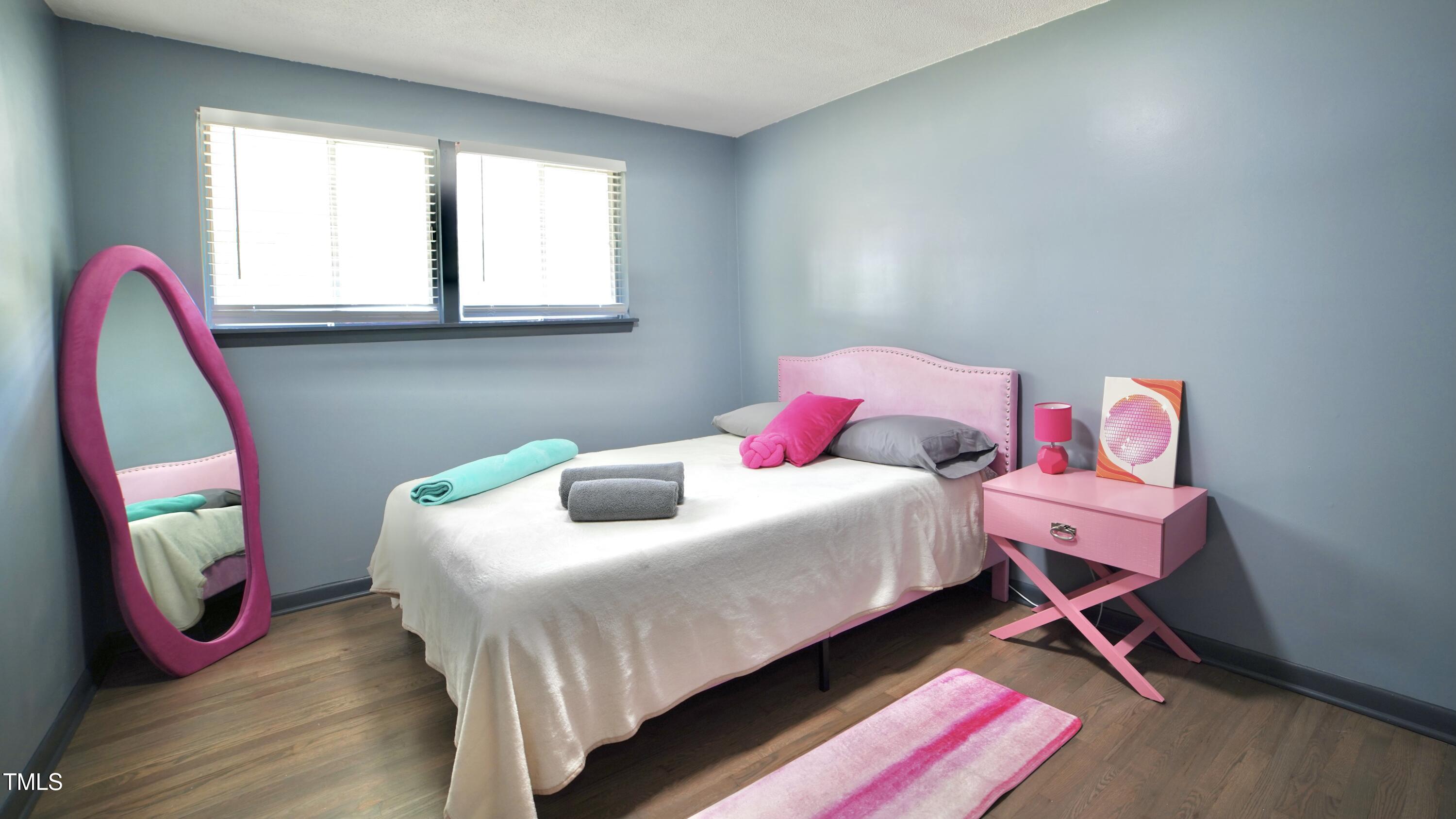 2006 Waters Drive Raleigh, NC 27610 - Photo 11 of 16 a bedroom with a bed and wooden floor