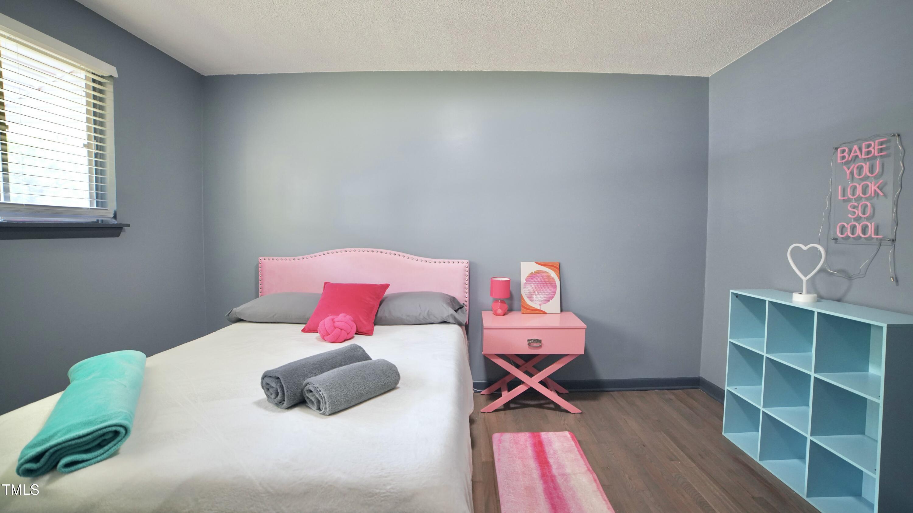 2006 Waters Drive Raleigh, NC 27610 - Photo 12 of 16 a bedroom with a bed and a window