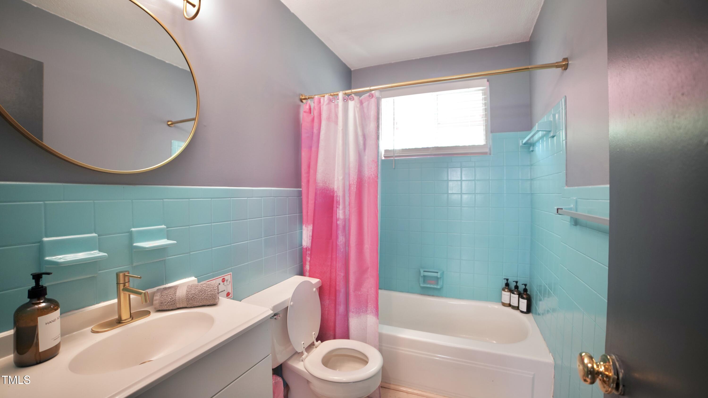 2006 Waters Drive Raleigh, NC 27610 - Photo 13 of 16 a bathroom with a sink a bathtub and a mirror