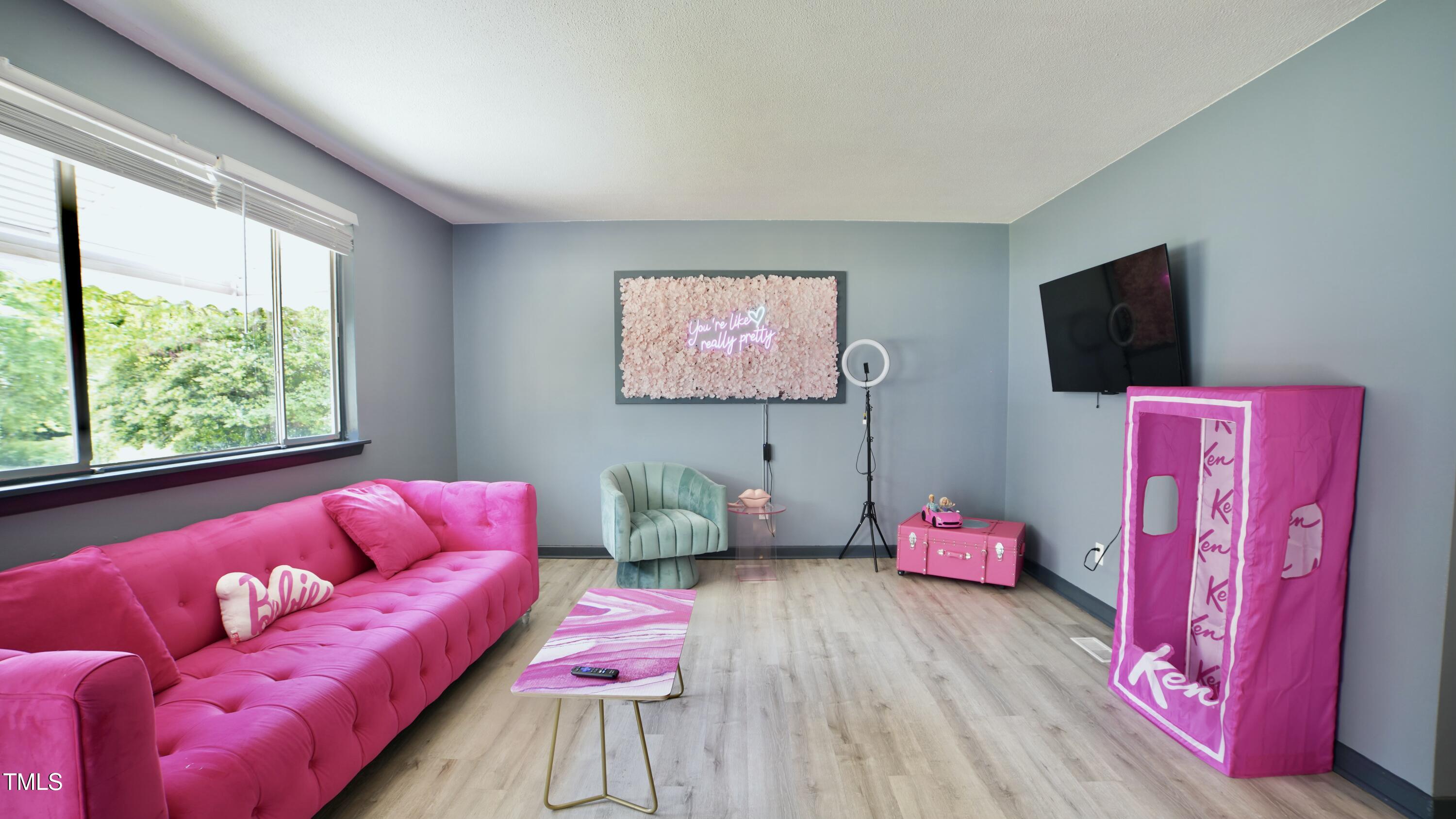 2006 Waters Drive Raleigh, NC 27610 - Photo 4 of 16 a living room with furniture and a flat screen tv