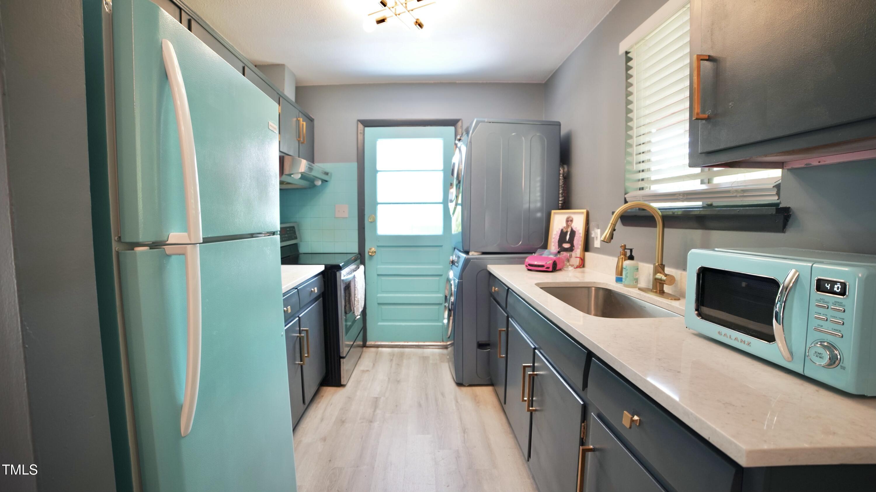 2006 Waters Drive Raleigh, NC 27610 - Photo 8 of 16 a kitchen with a sink a refrigerator and washer