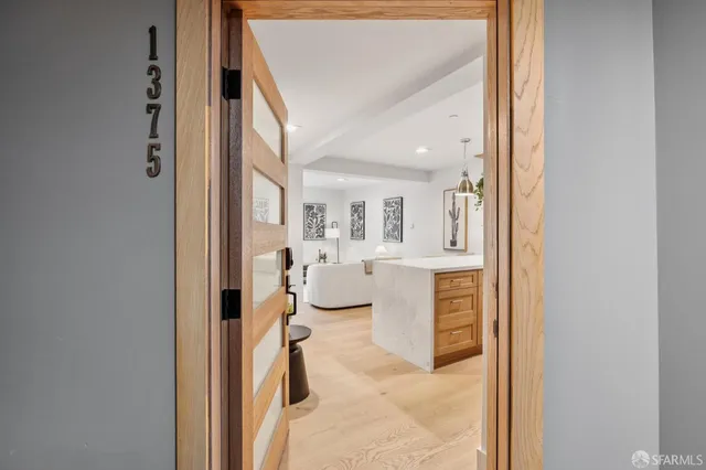 a kitchen with stainless steel appliances granite countertop a sink and a refrigerator