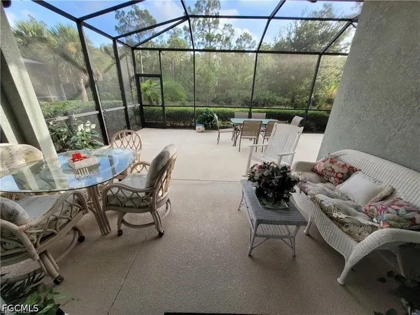 a dining room with furniture and a potted plant