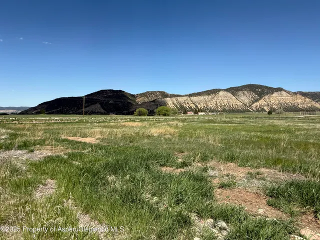 a view of a mountain with an outdoor space and seating area