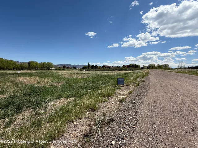 a view of a lake with houses in the back