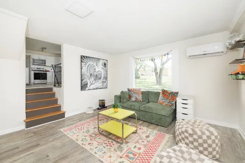a living room with furniture and wooden floor