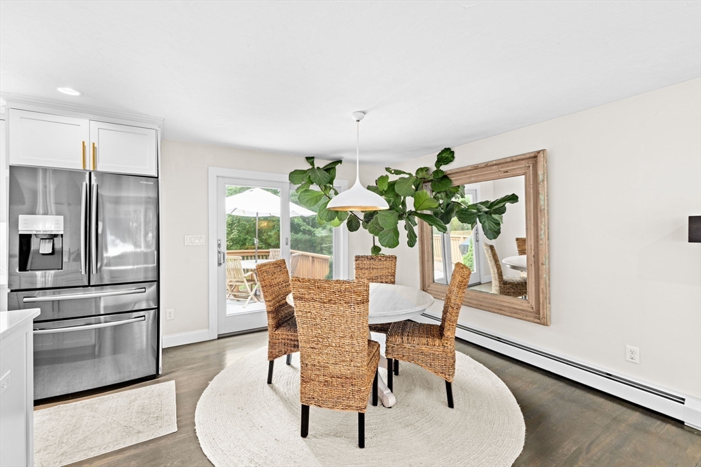 40 Brewster Road Cohasset, MA 02025 - Photo 11 of 42 a dining room with furniture potted plants and wooden floor
