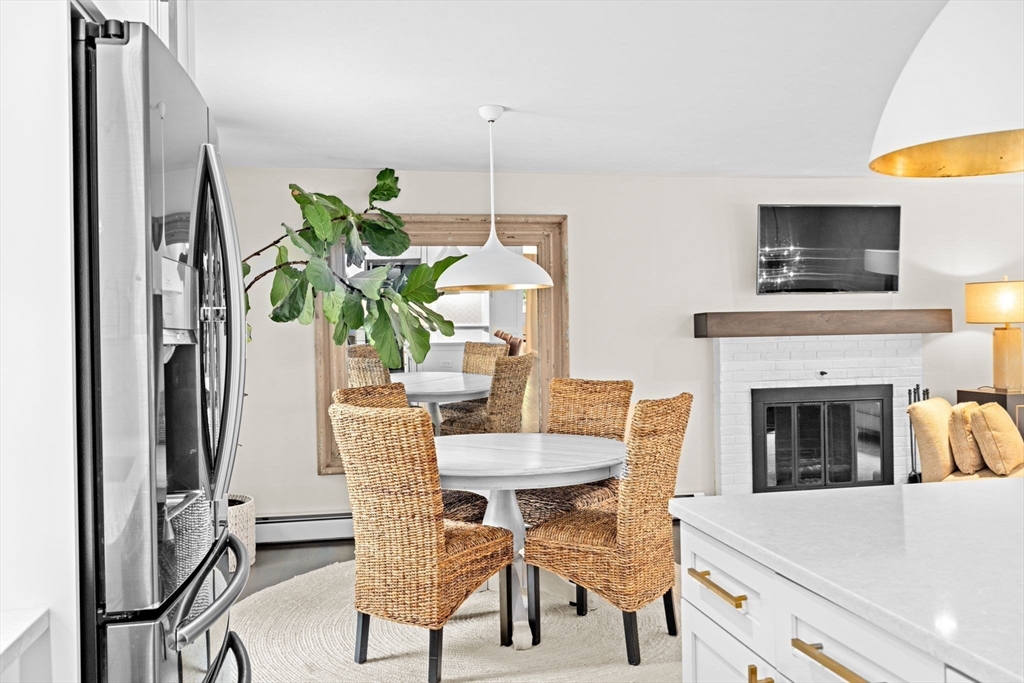 40 Brewster Road Cohasset, MA 02025 - Photo 12 of 42 a view of a dining room with furniture a fireplace and wooden floor