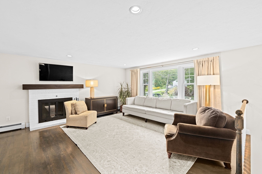 40 Brewster Road Cohasset, MA 02025 - Photo 13 of 42 a living room with furniture a fireplace and a flat screen tv