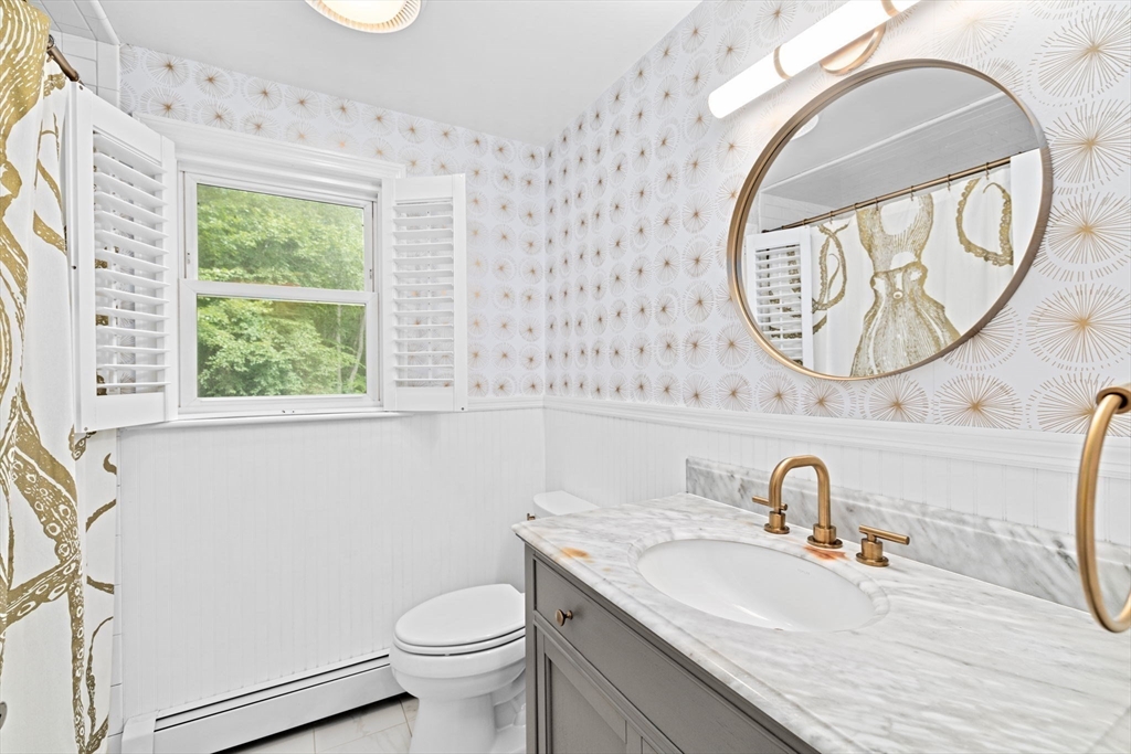 40 Brewster Road Cohasset, MA 02025 - Photo 23 of 42 a bathroom with a granite countertop toilet sink and mirror