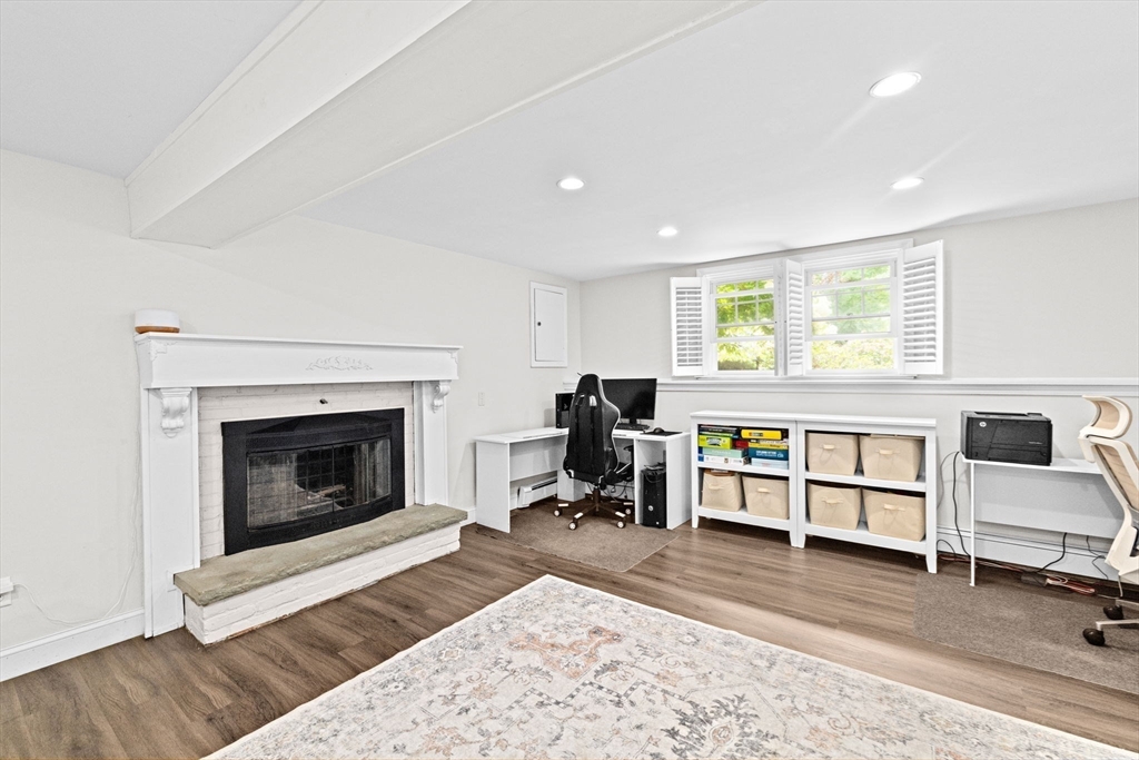 40 Brewster Road Cohasset, MA 02025 - Photo 26 of 42 a living room with furniture a fireplace and a window