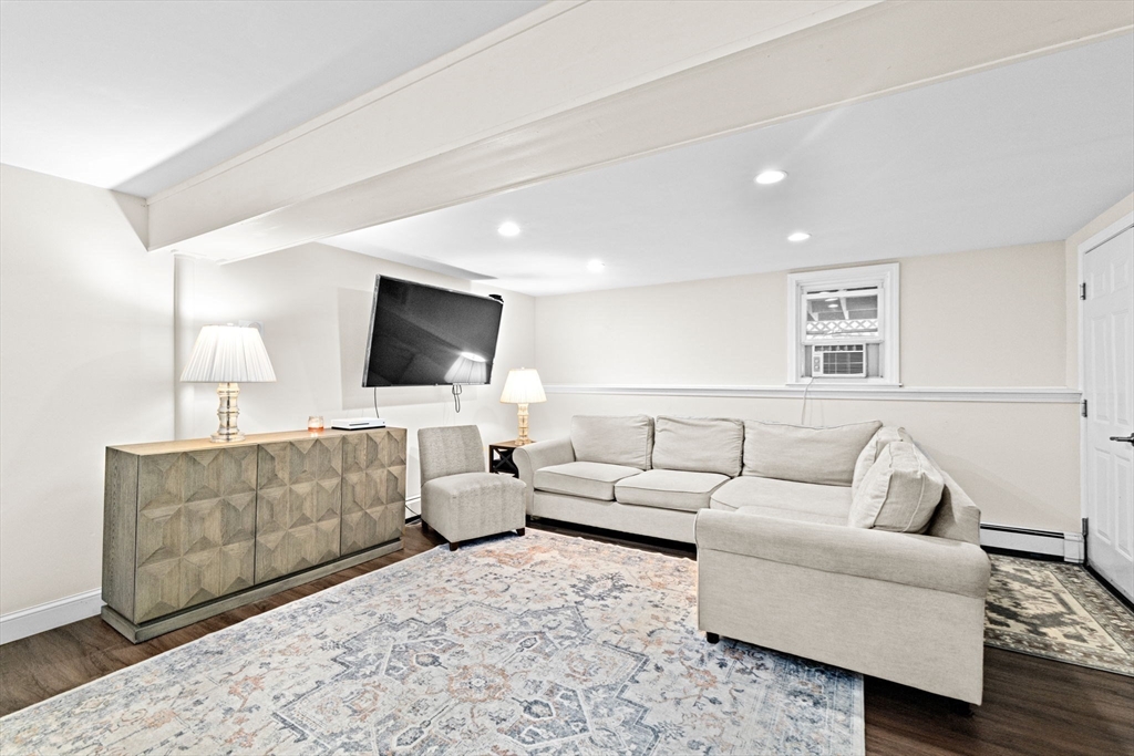 40 Brewster Road Cohasset, MA 02025 - Photo 27 of 42 a living room with furniture and a flat screen tv