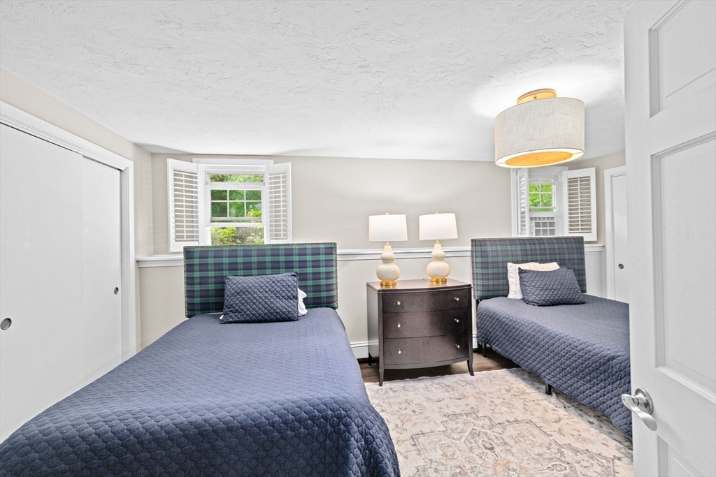 40 Brewster Road Cohasset, MA 02025 - Photo 30 of 42 a bedroom with a bed and a couch