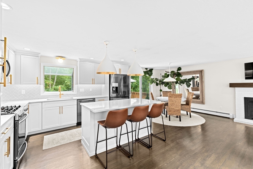 40 Brewster Road Cohasset, MA 02025 - Photo 3 of 42 a dining hall with granite countertop a stove a sink a dining table and chairs